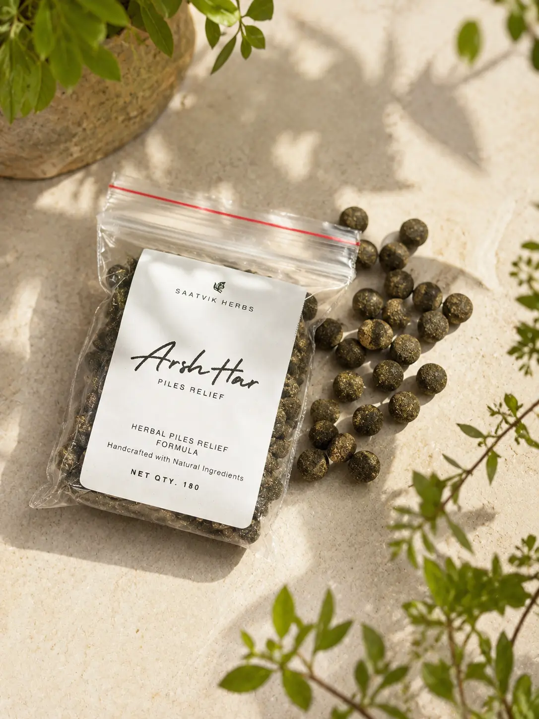 The ArshHar pouch open on a pale stone surface with the dark green herbal tablets tipped out beside it