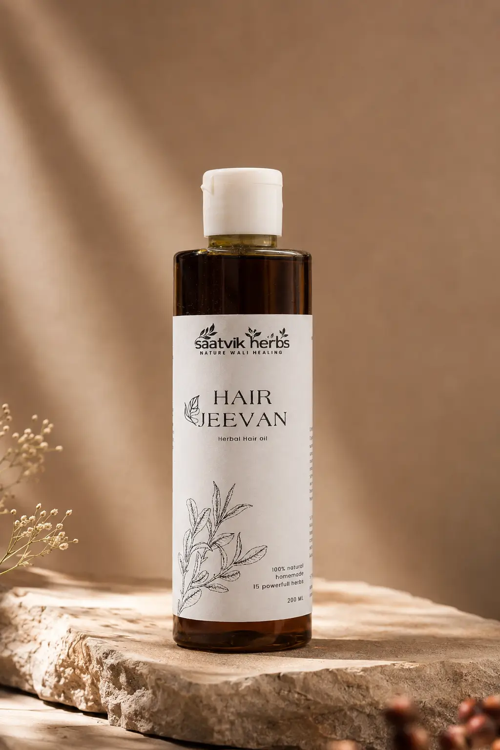 A bottle of Hair Jeevan herbal hair oil standing on a pale stone plinth in soft daylight, with leaf shadows on the wall behind