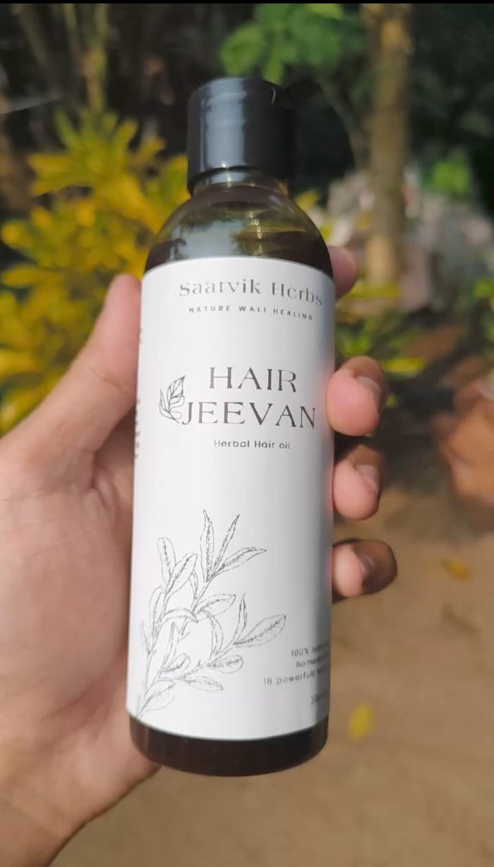 Hand holding a bottle of Hair Jeevan 100% natural herbal hair oil